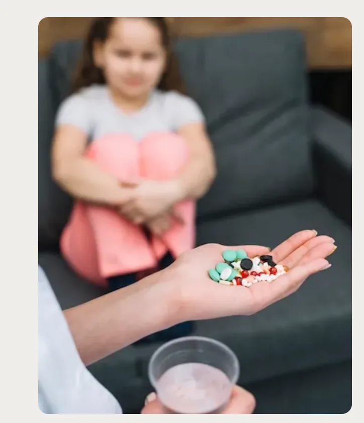 Clinician holding medication during a discussion with a young patient