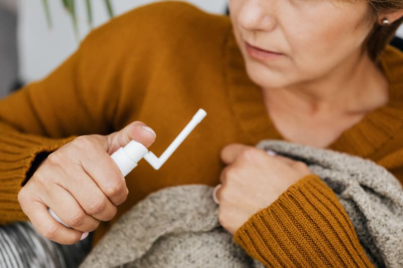 Patient using a nasal spray treatment