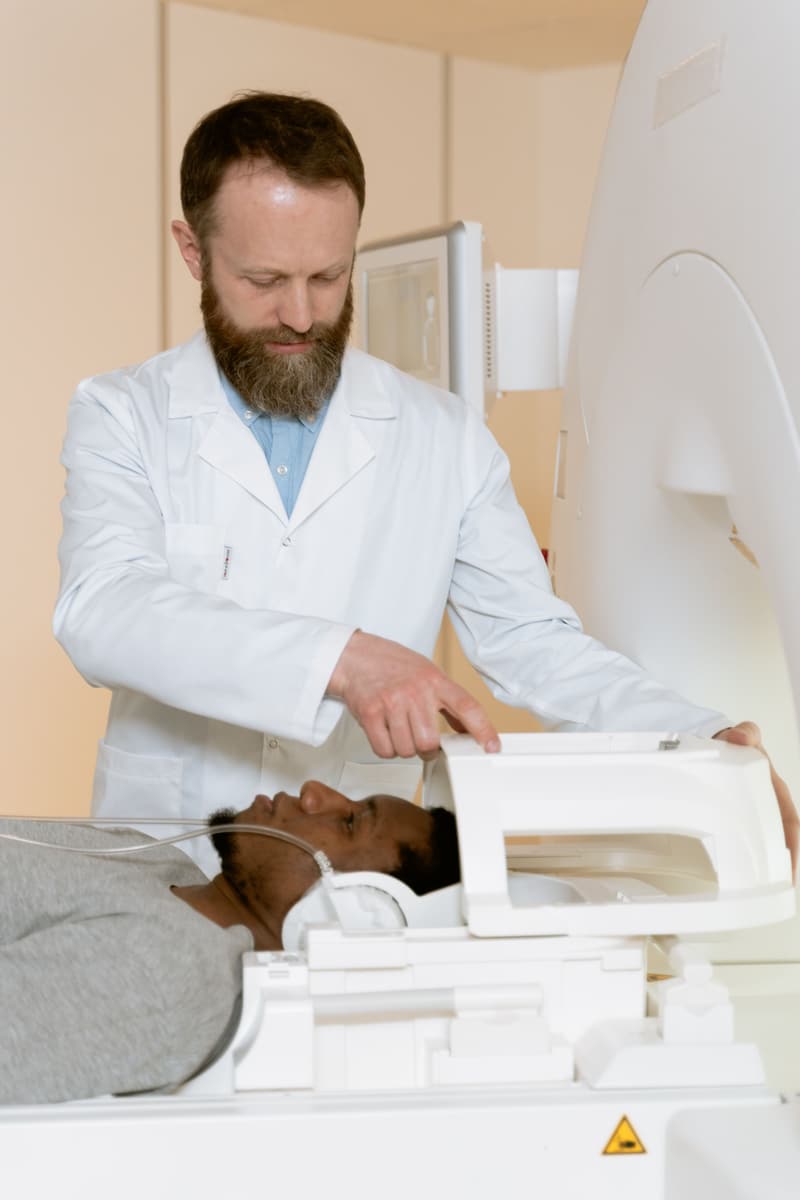 Clinician positioning a patient for TMS treatment